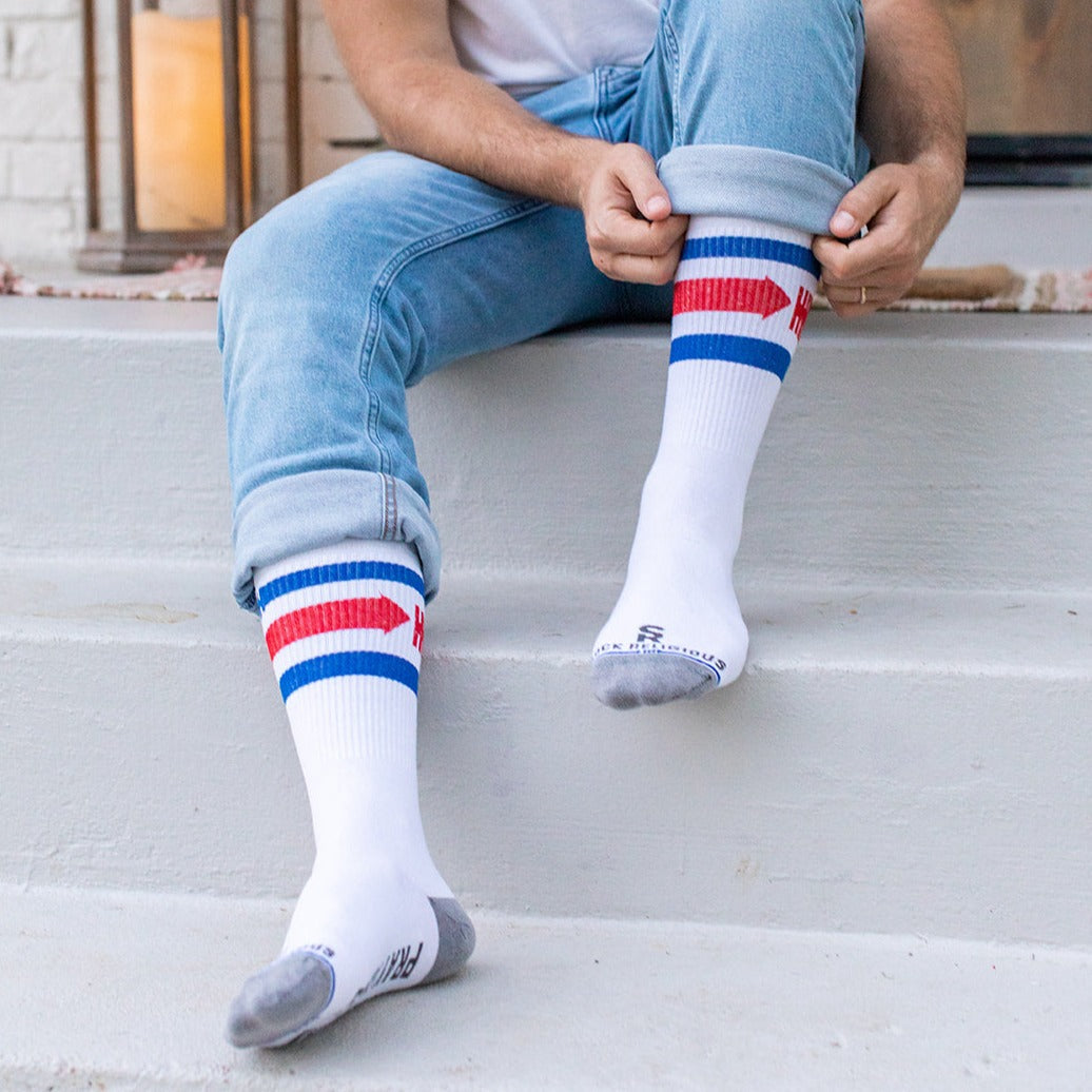 a man sitting on a step with his legs crossed