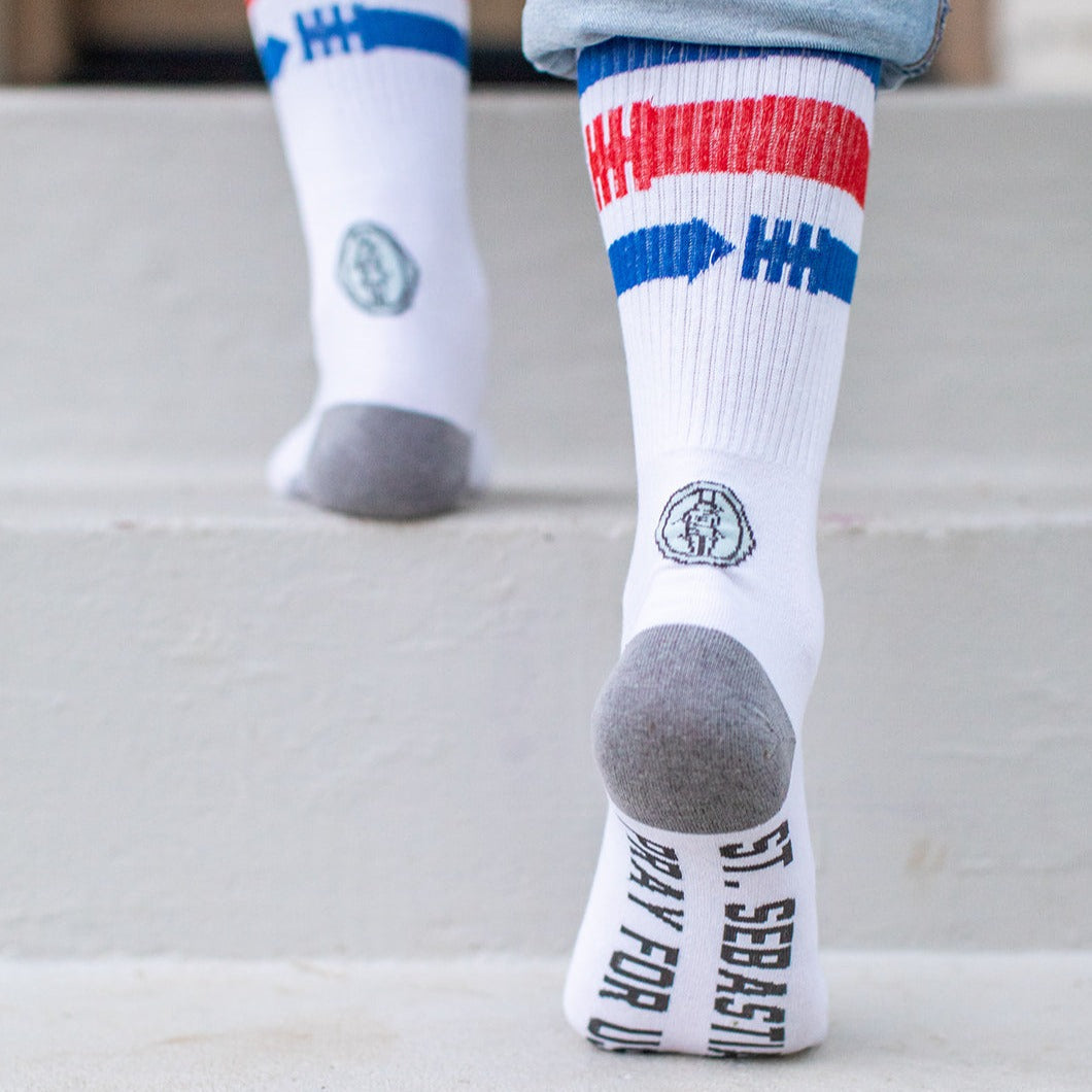 a person standing on a step with a pair of socks